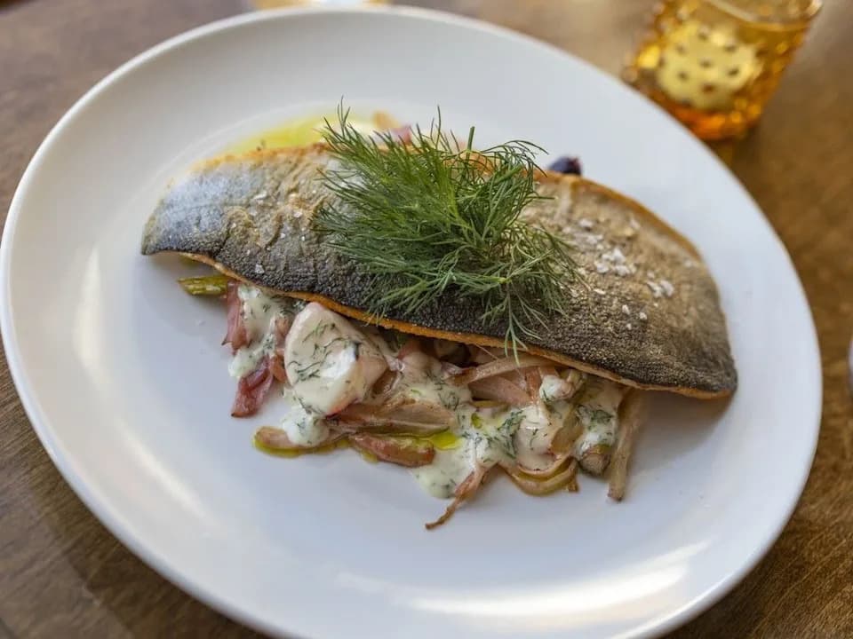Seasonal Alberta rainbow trout with fresh vegetables — Le Charme chef Nils Schneider's bistro menu, Calgary